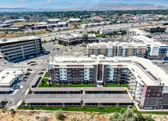 an aerial view of a city with buildings and cars
