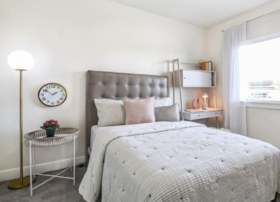a bedroom with a bed and a clock on the wall