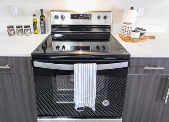 a kitchen with a stove and a dish towel on the oven