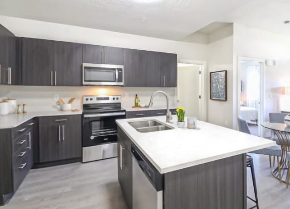 a kitchen with stainless steel appliances and a white counter top