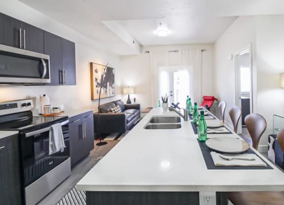 a kitchen and living room with a white counter top