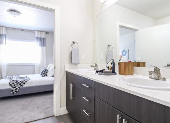 a bathroom with two sinks and a mirror