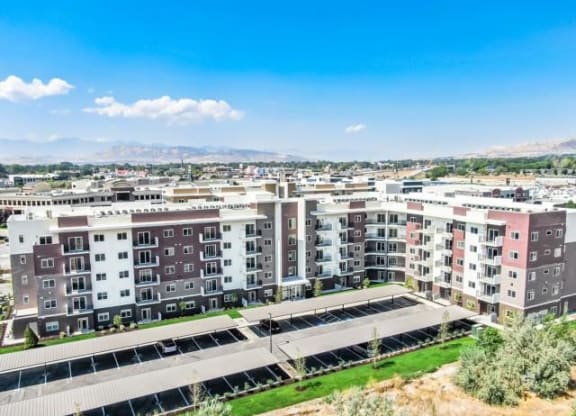 an aerial view of an apartment complex with a city in the background
