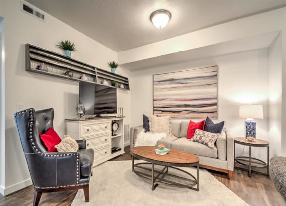 a living room with a couch and a table at Aderra apartments for rent in Roy, Utah