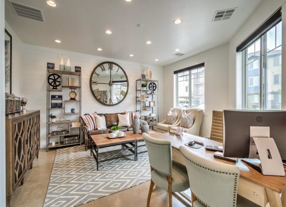 a large living room with a large clock on the wall at Aderra apartment complex available to rent in Roy, Utah