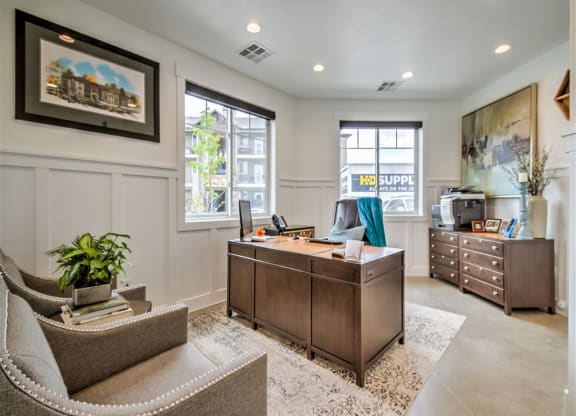 a home office with a desk and a chair at Aderra apartment complex in Roy, Utah