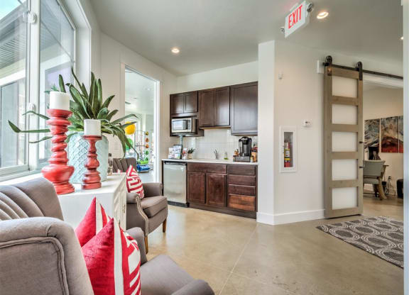 a spacious living room with a couch and a kitchen at Aderra apartments for rent in Roy, Utah
