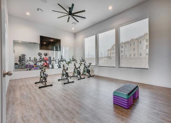 the home has a workout room with a slew of exercise bikes  at Affinity 56 Apartments in West Jordan, Utah