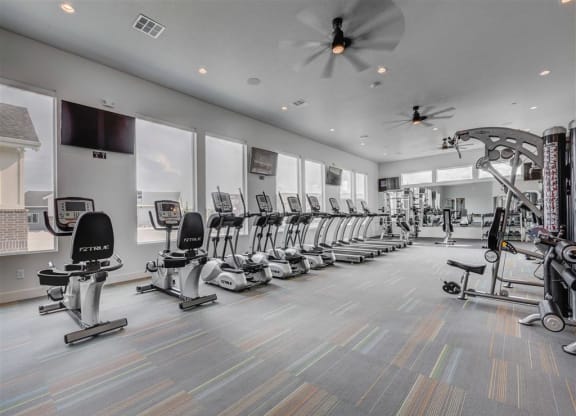 the gym is equipped with a row of exercise bikes  at Affinity 56 Apartments in West Jordan, Utah