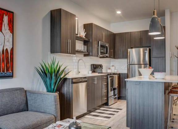 a kitchen with stainless steel  appliances and a counter top  at Affinity 56 Apartments in West Jordan, Utah