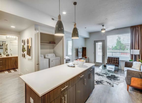 a kitchen and living room in a house  at Affinity 56 Apartments in West Jordan, Utah