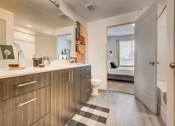 a large bathroom with a toilet and a sink  at Affinity 56 Apartments in West Jordan, Utah