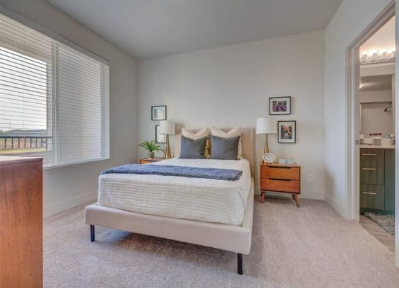 a bedroom with a bed and a closet  at Affinity 56 Apartments in West Jordan, Utah