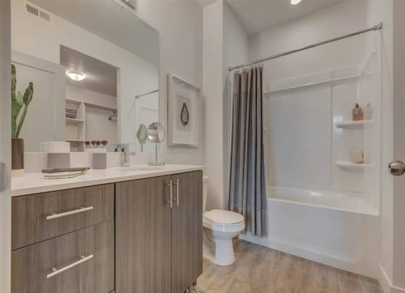 a bathroom with a shower and a toilet and a sink  at Affinity 56 Apartments in West Jordan, Utah