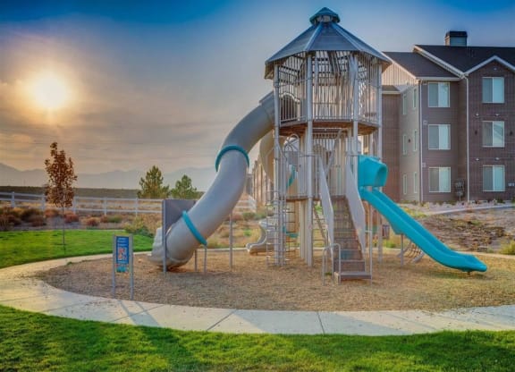 a playground with a  and a slide  at Affinity 56 Apartments in West Jordan, Utah