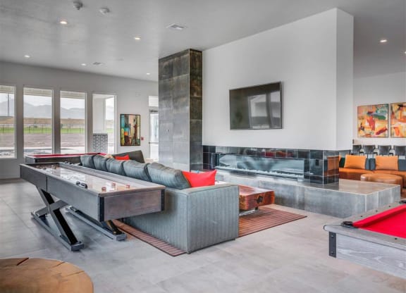 the living room has a pool table and a fireplace  at Affinity 56 Apartments in West Jordan, Utah