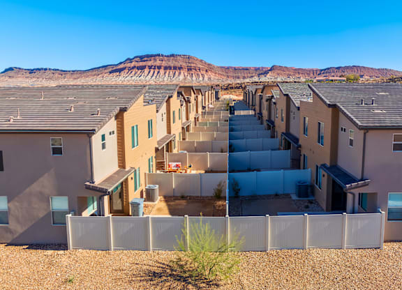 A row of houses with a mountain in the background.