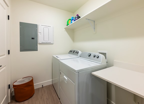A small laundry room with a washer and dryer.