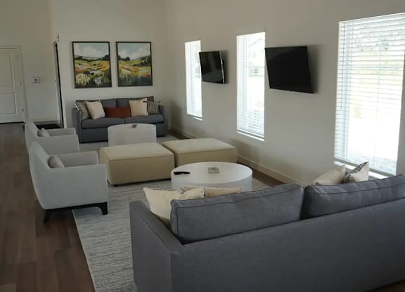 A living room with a grey couch and a white coffee table.