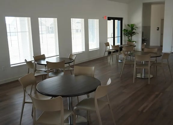 A room with a table and chairs in it.