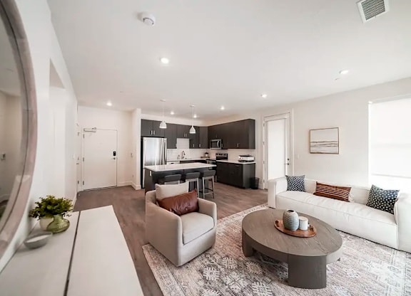 A modern living room with a grey coffee table and a white sofa.