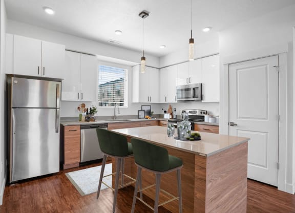 an updated kitchen with stainless steel appliances and white cabinets