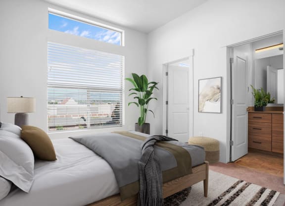 a bedroom with a bed and a large window