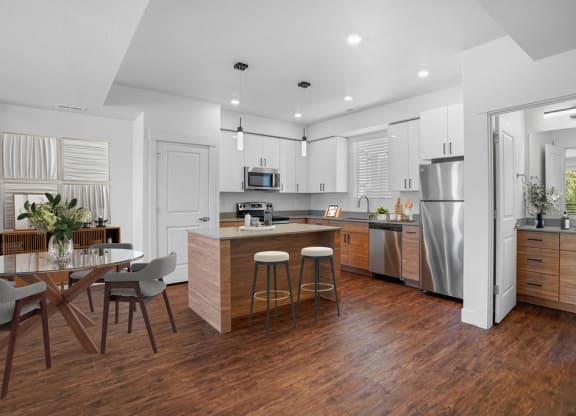 an open kitchen and dining area with a table and chairs