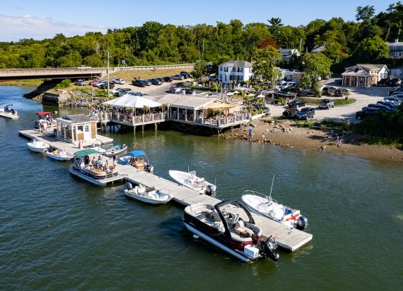 a group of boats docked in the water at a marina