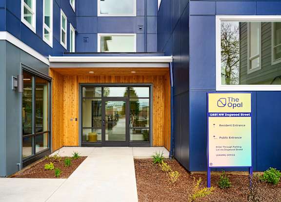 The entrance to a building with a sign that says "The Opal".