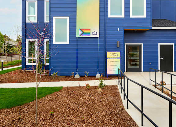 A blue building with a sign that says "The Opal".