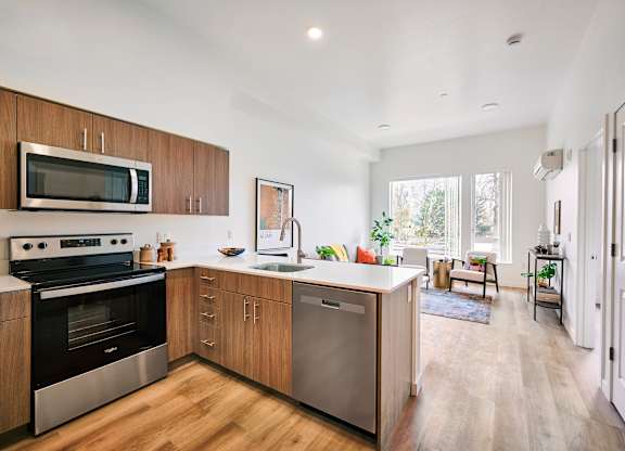 A kitchen with wooden cabinets and stainless steel appliances.