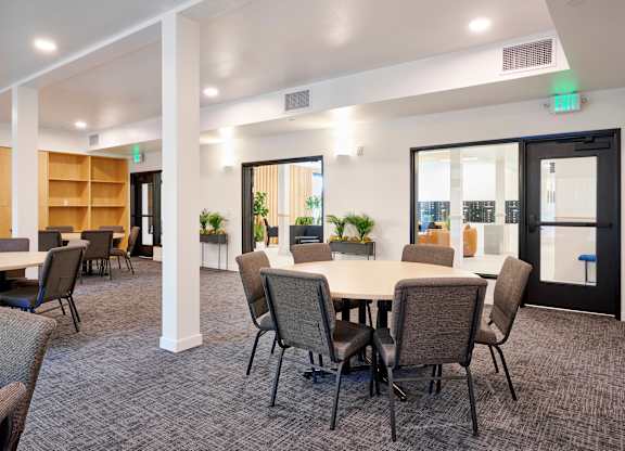 A conference room with a long table and chairs.