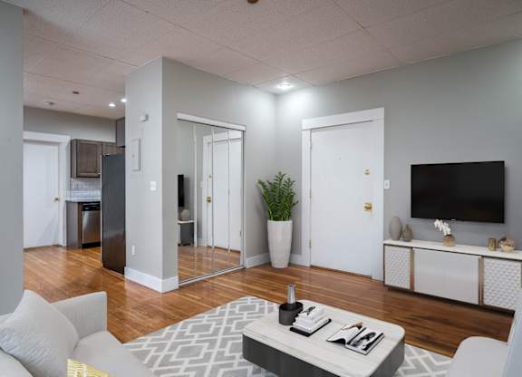 A modern living room with a grey sofa and a grey coffee table.