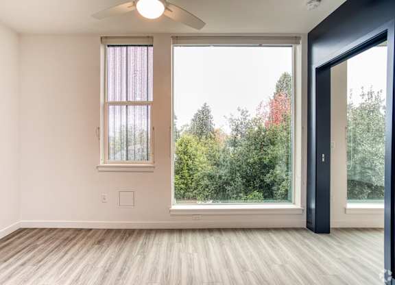 A room with a window and a ceiling fan.