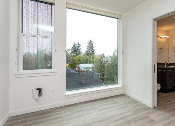 A room with a sliding glass door leading to a backyard.