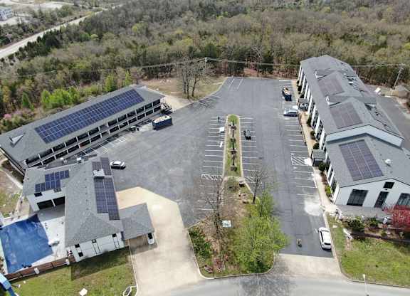 an aerial view of a building with solar panels on the roof at Schaefer Ridge Apartments, Branson , MO