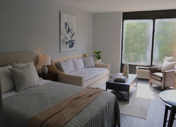 a bedroom with two beds and a couch and a table at Schaefer Ridge Apartments, Branson
