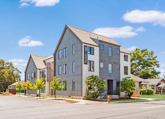 A modern two-story building with a flat roof and a large front yard at Society 62 Apartments, Portland 97213