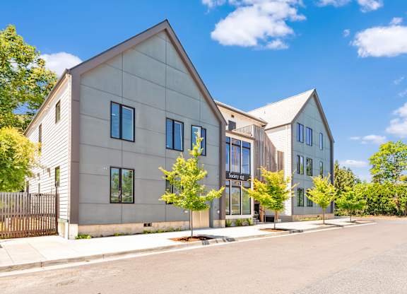 A modern house with a grey exterior and a black gate at Society 62 Apartments, Portland, Oregon