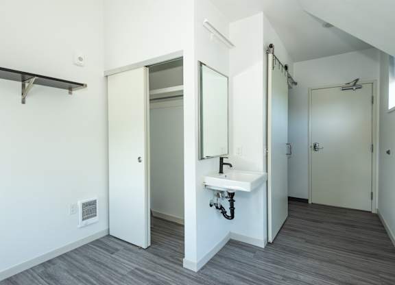 A bathroom with a sink and mirror at Society 62 Apartments, Portland, OR