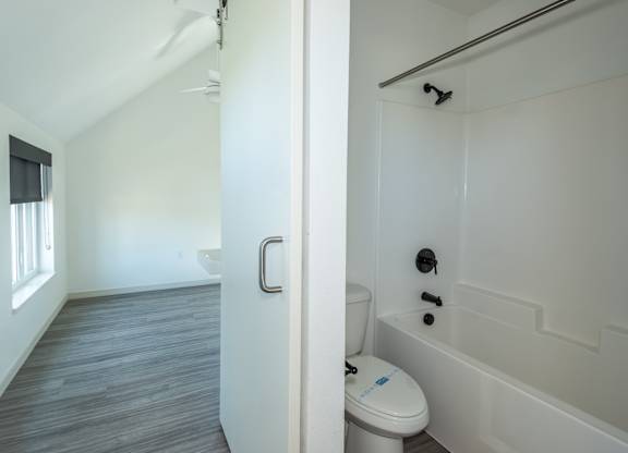 A white toilet with a blue sticker on it at Society 62 Apartments, Portland, OR, 97213