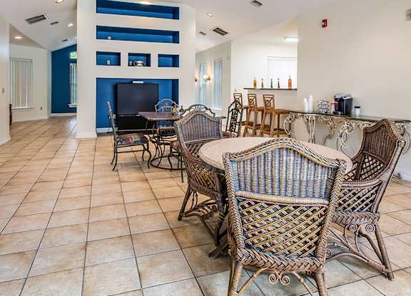 a dining room with tables and chairs and a bar