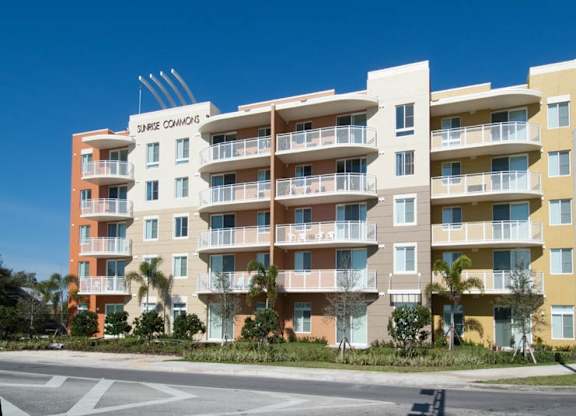 a large apartment building on the side of a street