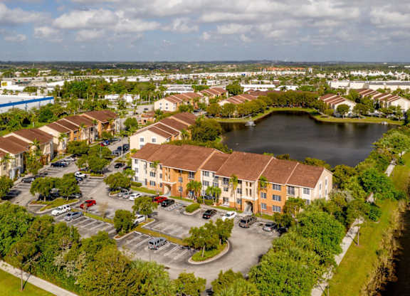 an aerial view of a row of houses next to a lake