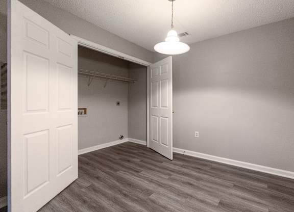 an empty bedroom with a closet and a door to the bathroom at Avon Crossings, North Carolina