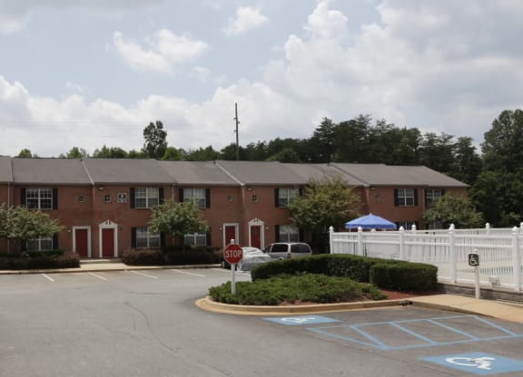 an apartment building with a parking lot in front of it at Brookside Pointe, Travelers Rest