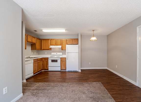A kitchen with white appliances and wooden cabinets.at Brookside Pointe Apartments, Travelers Rest, 29690