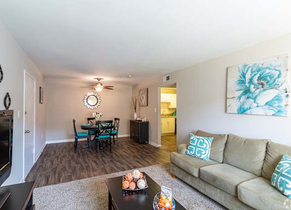A living room with a couch, a coffee table, and a television.at Bradley Square, North Charleston, SC