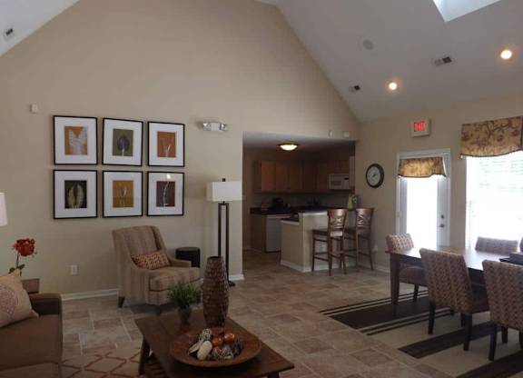 A living room with a brown couch and a coffee table.